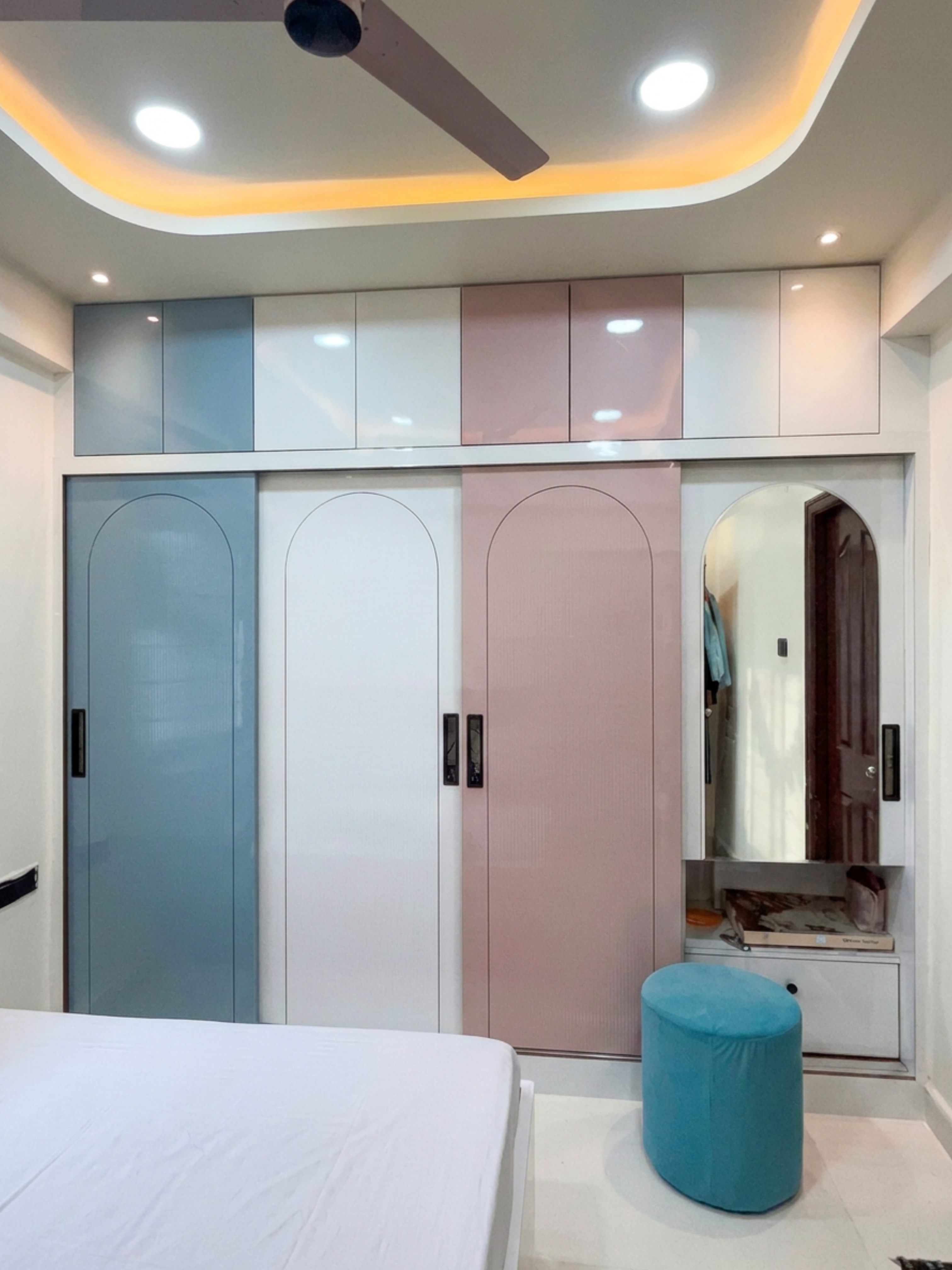 A BHK - Pastel Interiors with Sliding Wardrobes and Carved Partitions